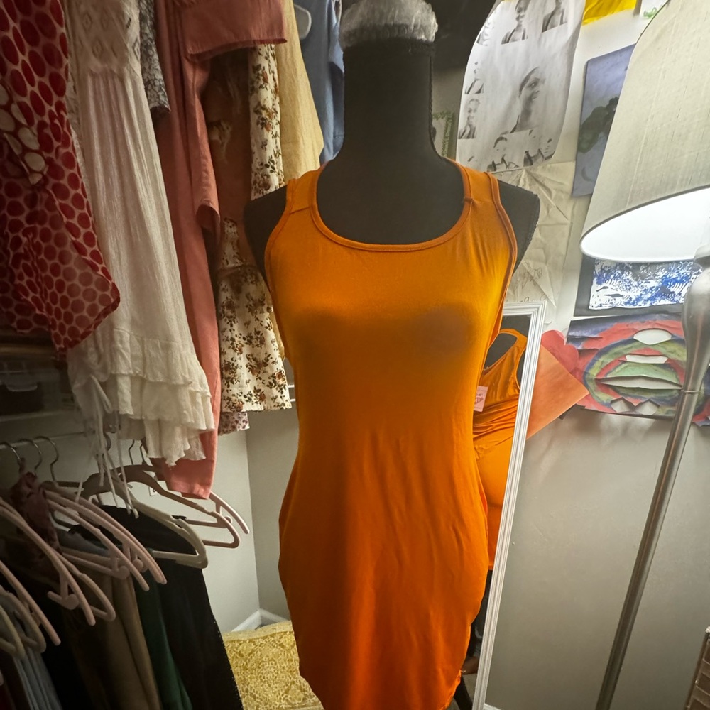 Small orange dress with partial back out. Real cute as party dress!